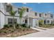 Charming townhome exterior with lush landscaping and a welcoming covered front porch at 4834 Lullaby Ln, Kissimmee, FL 34746