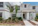 Inviting townhome featuring a well-maintained front yard and covered entry at 4834 Lullaby Ln, Kissimmee, FL 34746