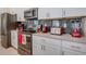 Well-equipped kitchen with stainless steel appliances and stylish gray backsplash at 4834 Lullaby Ln, Kissimmee, FL 34746