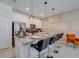 Modern kitchen island with sleek countertops, bar stools, and pendant lighting at 4834 Lullaby Ln, Kissimmee, FL 34746