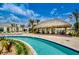 Enjoy the community lazy river and tiki bar with lounge seating and lush landscaping at 4834 Lullaby Ln, Kissimmee, FL 34746