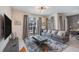 Comfortable living room with a gray sofa, a view of the pool area, and access to the dining space at 4834 Lullaby Ln, Kissimmee, FL 34746