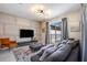 Cozy living room with modern decor, a large TV, a comfortable sofa, and sliding doors leading to the pool area at 4834 Lullaby Ln, Kissimmee, FL 34746