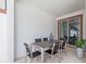 Inviting covered patio with a dining table, chairs and sliding door access at 4834 Lullaby Ln, Kissimmee, FL 34746