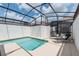Sparkling pool inside a screened-in enclosure with plenty of room for lounge chairs at 4834 Lullaby Ln, Kissimmee, FL 34746
