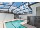 Relaxing pool area with sun loungers, a safety fence, and a screened-in enclosure at 4834 Lullaby Ln, Kissimmee, FL 34746