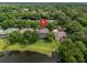 Aerial view of the property featuring a screened-in pool and lush surroundings near the lake at 490 Wekiva Preserve Dr, Apopka, FL 32712