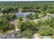 Aerial view of the home on a wooded lot and a tranquil lake surrounded by mature trees at 490 Wekiva Preserve Dr, Apopka, FL 32712
