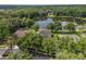 Aerial view of home with lake and mature trees surrounding the property at 490 Wekiva Preserve Dr, Apopka, FL 32712