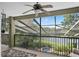 Enclosed balcony with ceiling fan and view of backyard pond at 490 Wekiva Preserve Dr, Apopka, FL 32712