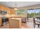Bright kitchen with modern appliances, a center island, and sliding glass doors leading to a screened pool area at 490 Wekiva Preserve Dr, Apopka, FL 32712