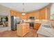 Spacious kitchen featuring stainless steel appliances, stone countertops and a functional center island at 490 Wekiva Preserve Dr, Apopka, FL 32712