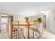 Bright and open landing area with wooden railing overlooking the foyer at 490 Wekiva Preserve Dr, Apopka, FL 32712