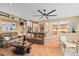 Expansive living room with a large ceiling fan, built-in bookshelves, and an open floor plan at 490 Wekiva Preserve Dr, Apopka, FL 32712