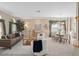 Open-concept living and dining room features stylish furniture, decor, and natural light at 490 Wekiva Preserve Dr, Apopka, FL 32712