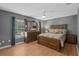 A spacious main bedroom features wood floors, a ceiling fan, and natural light at 490 Wekiva Preserve Dr, Apopka, FL 32712