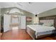 Large bedroom with wood floors, an ensuite bathroom, and a decorative light fixture at 490 Wekiva Preserve Dr, Apopka, FL 32712