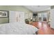 Spacious main bedroom featuring hardwood floors, double doors to balcony, and ensuite bath at 490 Wekiva Preserve Dr, Apopka, FL 32712