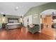 Large main bedroom featuring hardwood floors, a decorative bed, and a seating area at 490 Wekiva Preserve Dr, Apopka, FL 32712