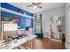 Bright home office with blue accent wall, built-in shelving, and comfortable work space at 490 Wekiva Preserve Dr, Apopka, FL 32712