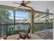 Enjoy the serene view from this screened-in patio with a ceiling fan and comfortable rocking chairs at 490 Wekiva Preserve Dr, Apopka, FL 32712