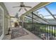 Spacious screened-in patio overlooking a peaceful lake provides an ideal spot for relaxation and entertaining at 490 Wekiva Preserve Dr, Apopka, FL 32712