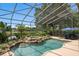 This screened-in pool with rock waterfall has a backdrop of lush landscaping and a view of a tranquil lake at 490 Wekiva Preserve Dr, Apopka, FL 32712