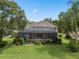 Aerial view showcasing a screened-in pool and backyard, with mature trees at 490 Wekiva Preserve Dr, Apopka, FL 32712