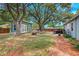 Spacious backyard featuring a detached structure, outdoor seating, and lush greenery at 5032 Timber Ridge Trl, Ocoee, FL 34761