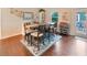 Stylish dining area featuring wood floors, ample seating, and modern decor at 5032 Timber Ridge Trl, Ocoee, FL 34761