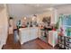 Open kitchen with stainless appliances, marble countertops, and seamless flow to the dining area at 5032 Timber Ridge Trl, Ocoee, FL 34761