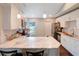 Bright kitchen with white cabinets, stainless steel appliances, and marble countertops at 5032 Timber Ridge Trl, Ocoee, FL 34761