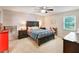 Comfortable main bedroom featuring a ceiling fan, a large window, and carpeted floors at 5032 Timber Ridge Trl, Ocoee, FL 34761