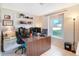 Functional home office with natural light from the window and carpeted floors at 5032 Timber Ridge Trl, Ocoee, FL 34761