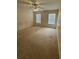Carpeted bedroom featuring two windows with blinds and a ceiling fan at 6024 Chapledale Dr, Orlando, FL 32829