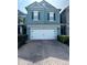 Charming two-story home with a brick driveway and a two-car garage in a well-maintained community at 6024 Chapledale Dr, Orlando, FL 32829