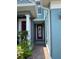 Inviting covered entryway with a red door and sidelights, offering a warm welcome to the home at 6024 Chapledale Dr, Orlando, FL 32829