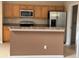 View of the kitchen with stainless steel appliances and a breakfast bar at 6024 Chapledale Dr, Orlando, FL 32829