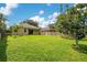 View of the back yard with lush green grass and a wood fence at 608 Ashwell Ct, Debary, FL 32713