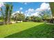 Back yard with lush green grass and a wood fence line surrounding the property at 608 Ashwell Ct, Debary, FL 32713