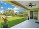 Covered patio that overlooks a lush green back yard with a wood fence at 608 Ashwell Ct, Debary, FL 32713