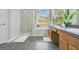 Primary bathroom features dual sink vanity, separate step-in shower, and garden tub at 608 Ashwell Ct, Debary, FL 32713