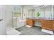 Primary bathroom with dual sink vanity, step-in shower and garden tub at 608 Ashwell Ct, Debary, FL 32713