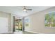 Bedroom with neutral walls, slider to porch, large windows with blinds, and modern ceiling fan at 608 Ashwell Ct, Debary, FL 32713