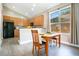 Eat-in kitchen dining area featuring wood cabinets, stainless appliances, and light-filled window at 608 Ashwell Ct, Debary, FL 32713