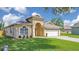 Inviting single-story home with manicured lawn and front-facing two-car garage at 608 Ashwell Ct, Debary, FL 32713