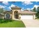 Inviting single-story home with well-manicured lawn, arched entryway and two-car garage at 608 Ashwell Ct, Debary, FL 32713