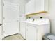 Laundry room with washer, dryer, white cabinets and white walls at 608 Ashwell Ct, Debary, FL 32713