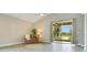 Light and bright living room features vaulted ceilings, large sliding doors to patio, and light gray flooring at 608 Ashwell Ct, Debary, FL 32713