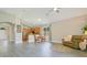 Open-concept living room with kitchen views, wood floors, and ample natural light at 608 Ashwell Ct, Debary, FL 32713